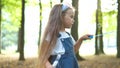 Happy little child girl blowing soap bubbles outside in green park. Outdoor summer activities for children concept Royalty Free Stock Photo