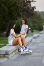 Happy little child girl and her mother are wearing roller skates Royalty Free Stock Photo