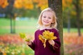 Happy little child, girl laughing and playing in autumn park Royalty Free Stock Photo