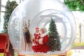 Happy little child girl and mother in santa costume dress has fun in big winter Snow globe with reindeer on christmas time. Merry Royalty Free Stock Photo