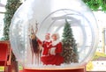 Happy little child girl and mother in santa costume dress has fun in big winter Snow globe with reindeer on christmas time. Merry Royalty Free Stock Photo