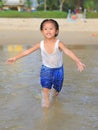 Happy little child girl running on the beach in summer times Royalty Free Stock Photo