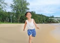 Happy little child girl running on the beach in summer times Royalty Free Stock Photo