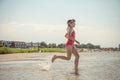 Happy little child girl running and having fun on beach at sunny summer day Royalty Free Stock Photo