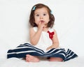 Happy little child girl sit on white towel, happy emotion and face expression, very surprised, the finger in mouth Royalty Free Stock Photo