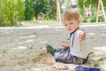 Happy little child having fun playing with sand and colorful toys in the park, beautiful summer sunny day in children playground Royalty Free Stock Photo