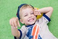 Happy little child lying on the green carpet Royalty Free Stock Photo