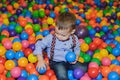 Happy little child playing at colorful plastic balls playground Royalty Free Stock Photo