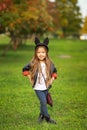 Happy little child posing for the camera, baby girl laughing and playing in the autumn on the nature walk outdoors. Royalty Free Stock Photo