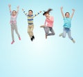 Happy little children jumping in air over blue Royalty Free Stock Photo