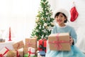 Cute Asian girl holding a Christmas gift box Royalty Free Stock Photo