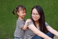 Happy little cute lovely baby girl Chinese child smile laugh have fun with mother mom at summer park nature happiness childhood Royalty Free Stock Photo