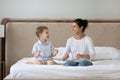 Joyful two generations mixed race family playing together in bedroom. Royalty Free Stock Photo