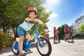 Happy little cyclist riding bike in summer city