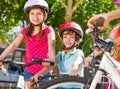 Happy little cyclists having fun at summer park Royalty Free Stock Photo