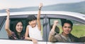 Happy little girl with asian family sitting in the car for enjo Royalty Free Stock Photo