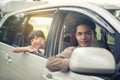 Happy little girl with asian family sitting in the car for enjo Royalty Free Stock Photo