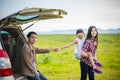 Happy little girl with asian family sitting in the car for enjo Royalty Free Stock Photo