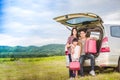 Happy little girl with asian family sitting in the car for enjo Royalty Free Stock Photo