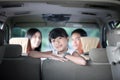 Happy little girl with asian family sitting in the car for enjo Royalty Free Stock Photo