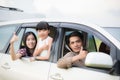 Happy little girl with asian family sitting in the car for enjo Royalty Free Stock Photo