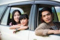 Happy little girl with asian family sitting in the car for enjo Royalty Free Stock Photo