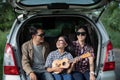 Happy little girl with asian family sitting in the car for enjoying road trip and summer vacation in camper van Royalty Free Stock Photo