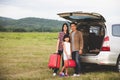 Happy little girl with asian family sitting in the car for enjoying road trip and summer vacation in camper van Royalty Free Stock Photo