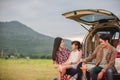 Happy little girl  with asian family sitting in the car for enjoying road trip and summer vacation in camper van Royalty Free Stock Photo