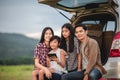 Happy little girl  with asian family sitting in the car for enjoying road trip and summer vacation in camper van Royalty Free Stock Photo