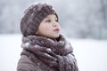 Happy little girl on the background of a winter park