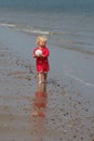 Happy little girl on the beach with a ball Royalty Free Stock Photo