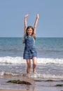 Happy little girl at the beach in Dawlish, Devon.