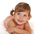 Happy little girl on the bedspread Royalty Free Stock Photo