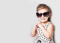 Happy little girl with big sunglasses. Fashionable baby Royalty Free Stock Photo