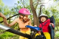 Happy little girl in bike seat with her mother Royalty Free Stock Photo