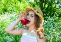 Happy little girl bite ripe red apple fruit in summer garden on sunny outdoors, vitamin Royalty Free Stock Photo