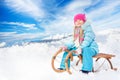 Happy little girl in blue on sledge Royalty Free Stock Photo