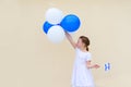 Happy little girl with blue and white balloons ans Israel flag. Royalty Free Stock Photo