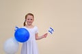Happy little girl with blue and white balloons ans Israel flag. Royalty Free Stock Photo