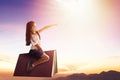 Happy little  girl on book and  flying in the sky Royalty Free Stock Photo