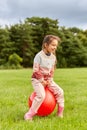 happy little girl bouncing on hopper ball at park Royalty Free Stock Photo