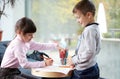 Happy little girl and boy drawing at home Royalty Free Stock Photo