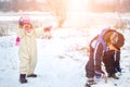 Happy little girl and boy playing in the snow on cold winter day. Royalty Free Stock Photo