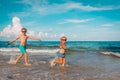 Happy little girl and boy run fly play with waves on beach Royalty Free Stock Photo