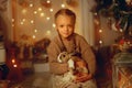 Happy little girl with brown rabbit at Christmas eve