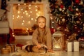 Happy little girl with brown rabbit at Christmas eve