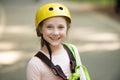 Happy little girl calling while climbing high tree and ropes. Climber child. Climber little girl on training. Kid
