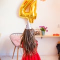 Happy little girl celebrating the fourth birthday at home Royalty Free Stock Photo