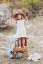 Happy little girl in a chair outdoors